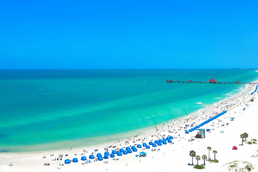 Pristine beach in Clearwater, FL with bright blue water and white sand