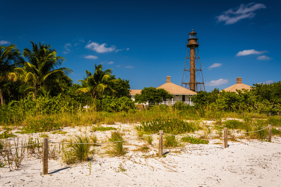 Sanibel island lighthouse with palm trees and sand 
