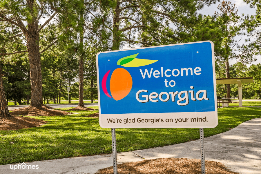 Welcome to Georgia sign with blue peach and park behind in Savannah GA