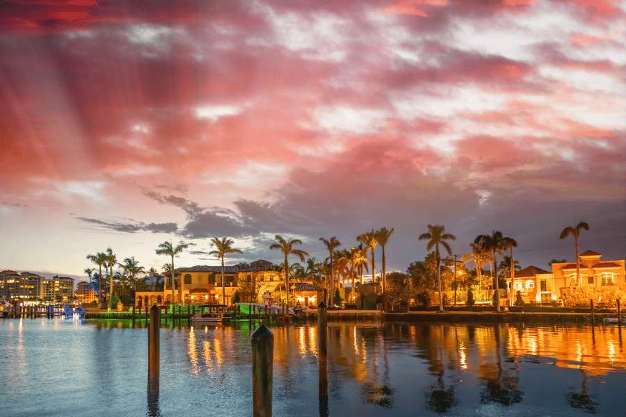 Orange and red sunset in Boca Raton, FL buildings reflecting light in the water