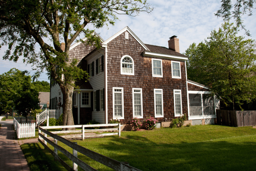 homes-in-lewes-de-brown-house-with-green-grass.png Brown Home in Lewes DE with green grass and fence