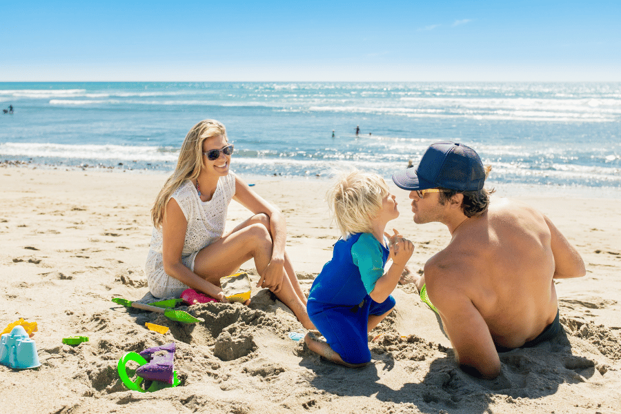 Family relaxing at the beach on a sunny day 