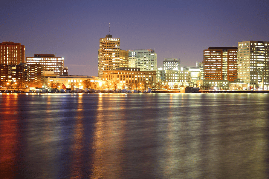 Cambridge-MA-night.png the city of Cambridge, MA at night with buildings near the water