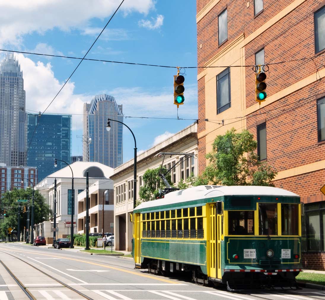 things-to-do-in-charlotte-nc-hero-image.jpg Charlotte NC skyline with the Q city trolley in the foreground - Fun things to do in Charlotte NC