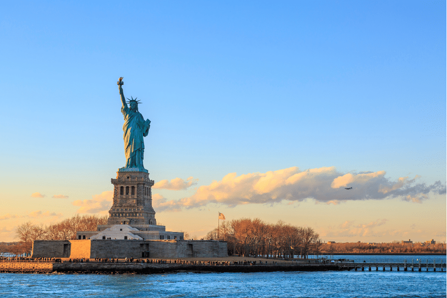 The Statue of Liberty near the water on a beautiful sunny day
